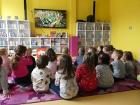 Przedszkolaki oglądają na ekranie telewizora zdjęcie kwiatów